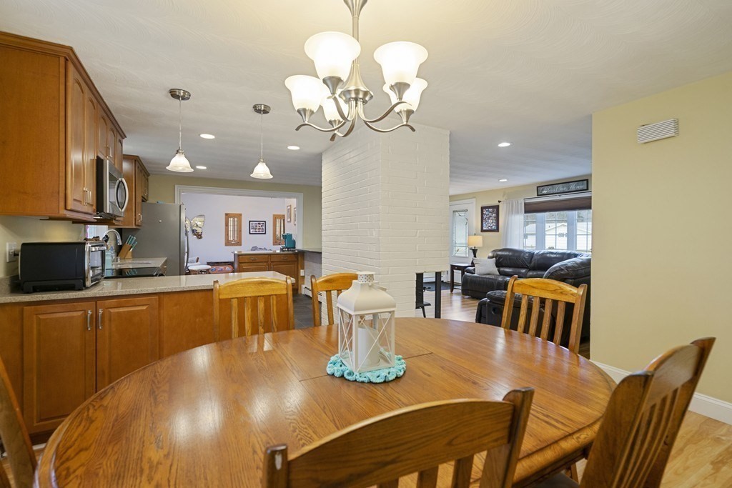 26 Edith Road Framingham, MA 01701 - Photo 15 of 42 a view of a dining room with furniture a chandelier and wooden floor