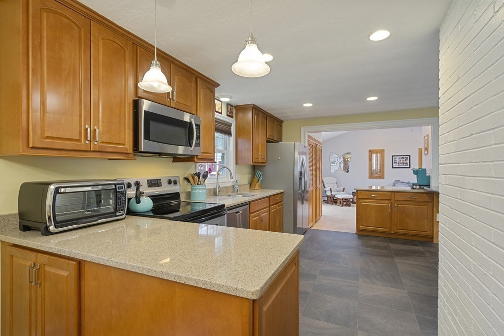 26 Edith Road Framingham, MA 01701 - Photo 16 of 42 a kitchen with stainless steel appliances a sink a stove top oven a counter space and cabinets