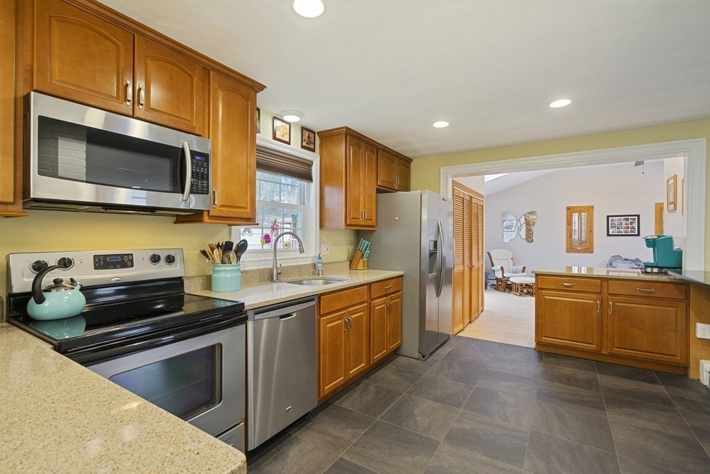 26 Edith Road Framingham, MA 01701 - Photo 17 of 42 a kitchen with stainless steel appliances granite countertop a stove a sink and a microwave