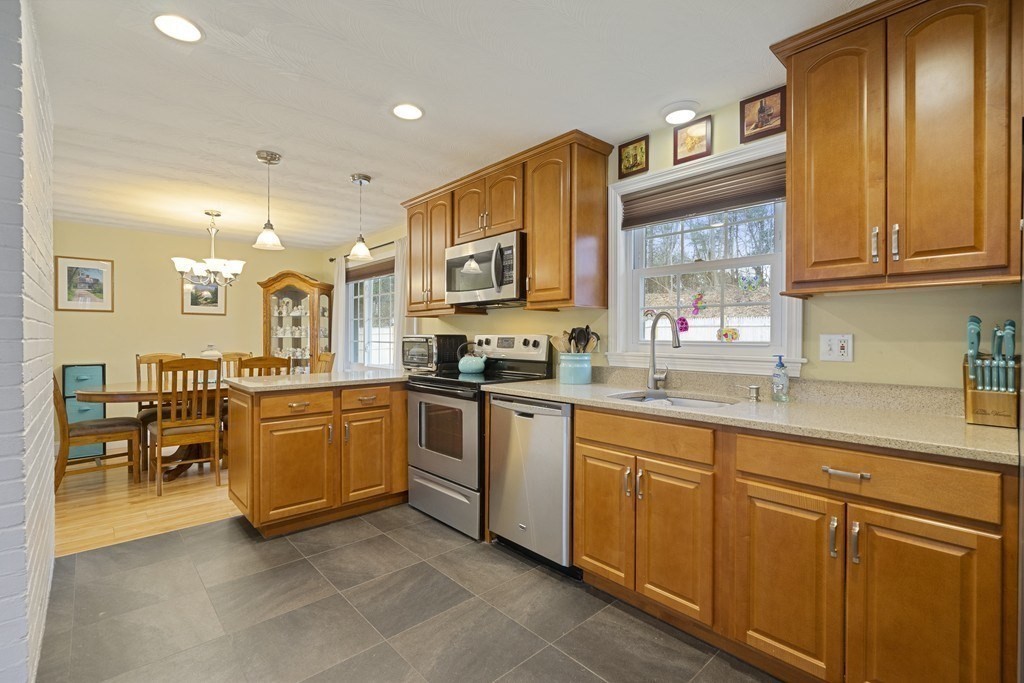 26 Edith Road Framingham, MA 01701 - Photo 18 of 42 a kitchen with stainless steel appliances granite countertop a sink and cabinets