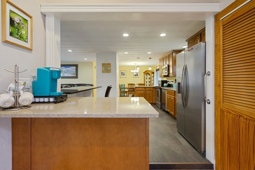 26 Edith Road Framingham, MA 01701 - Photo 19 of 42 a large kitchen with stainless steel appliances a refrigerator and a counter top space