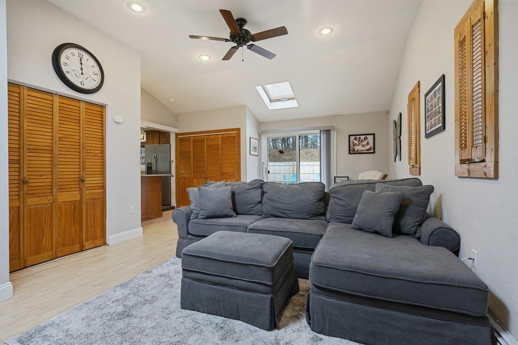 26 Edith Road Framingham, MA 01701 - Photo 23 of 42 a living room with furniture a large window and a clock