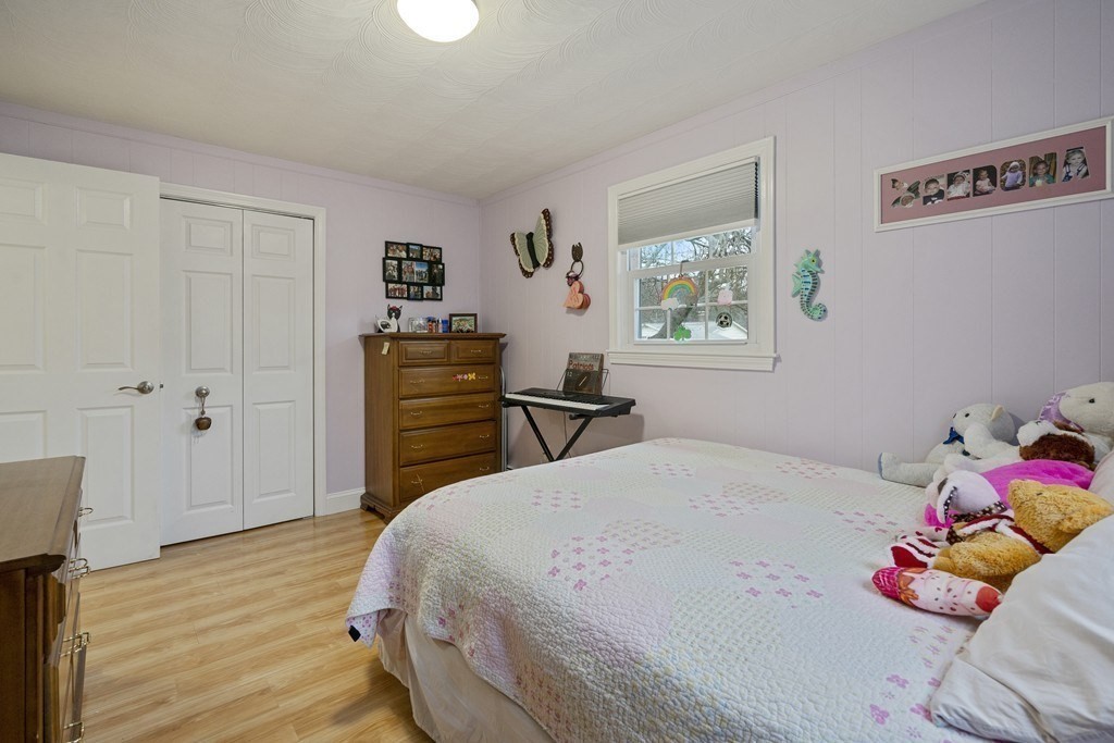 26 Edith Road Framingham, MA 01701 - Photo 27 of 42 a bedroom with a bed and wooden floor