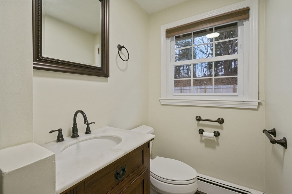 26 Edith Road Framingham, MA 01701 - Photo 31 of 42 a bathroom with a sink a toilet and mirror