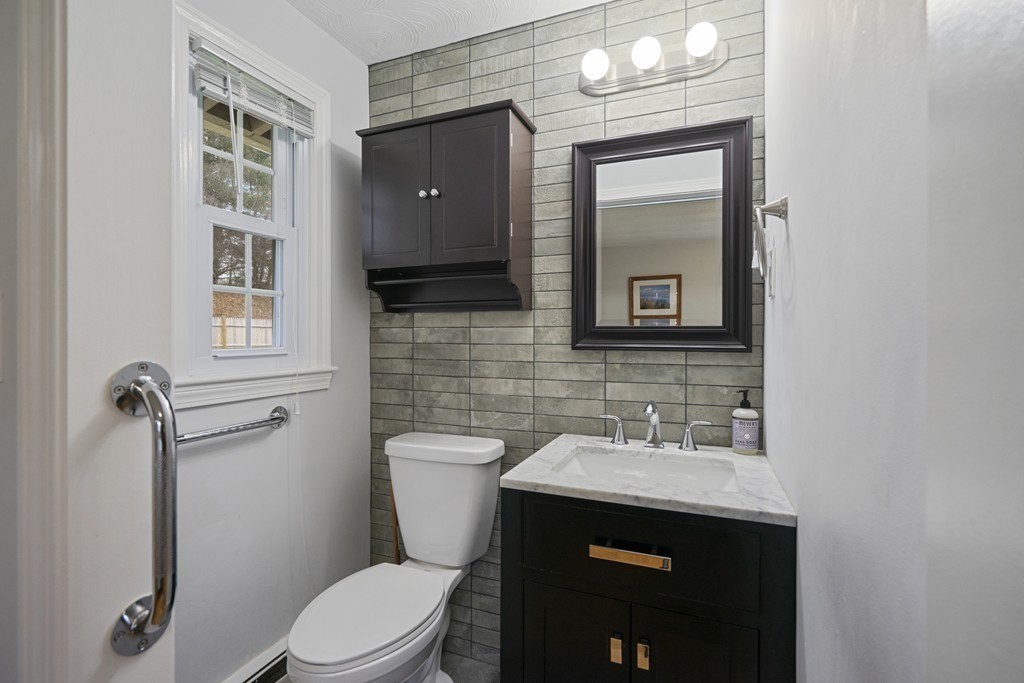 26 Edith Road Framingham, MA 01701 - Photo 32 of 42 a bathroom with a toilet sink and mirror