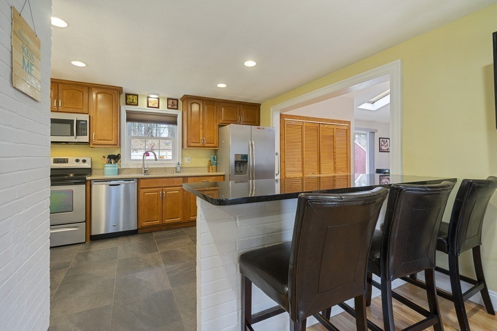 26 Edith Road Framingham, MA 01701 - Photo 10 of 42 a kitchen with a table chairs sink and cabinets