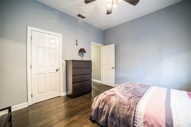 a bedroom with a bed and a dresser