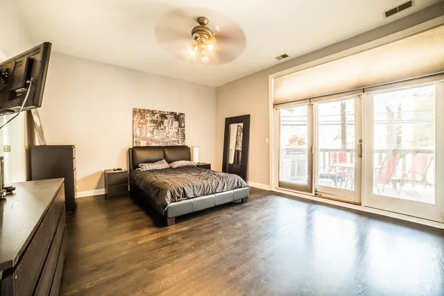 a spacious bedroom with a large bed and a large window