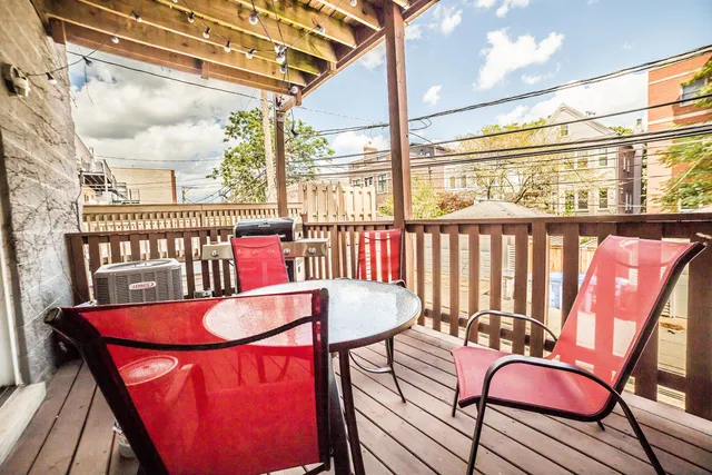 a view of a chairs and table in the balcony