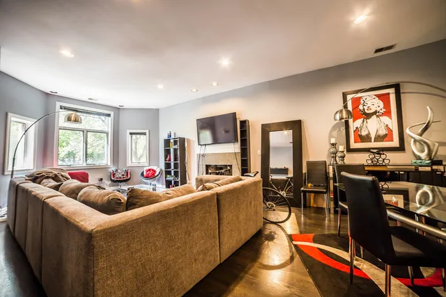 a living room with furniture fireplace and flat screen tv