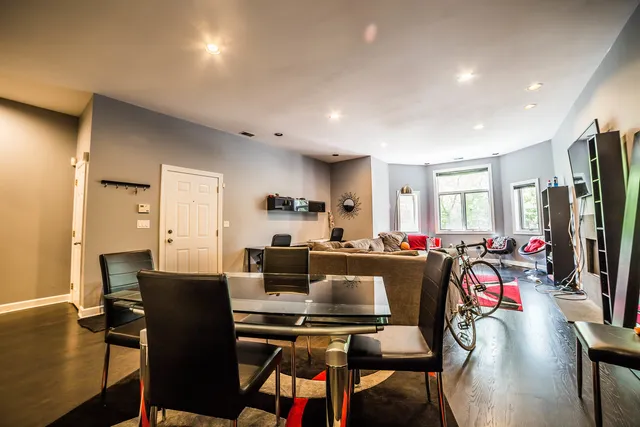 a view of a dining room with furniture a rug and wooden floor