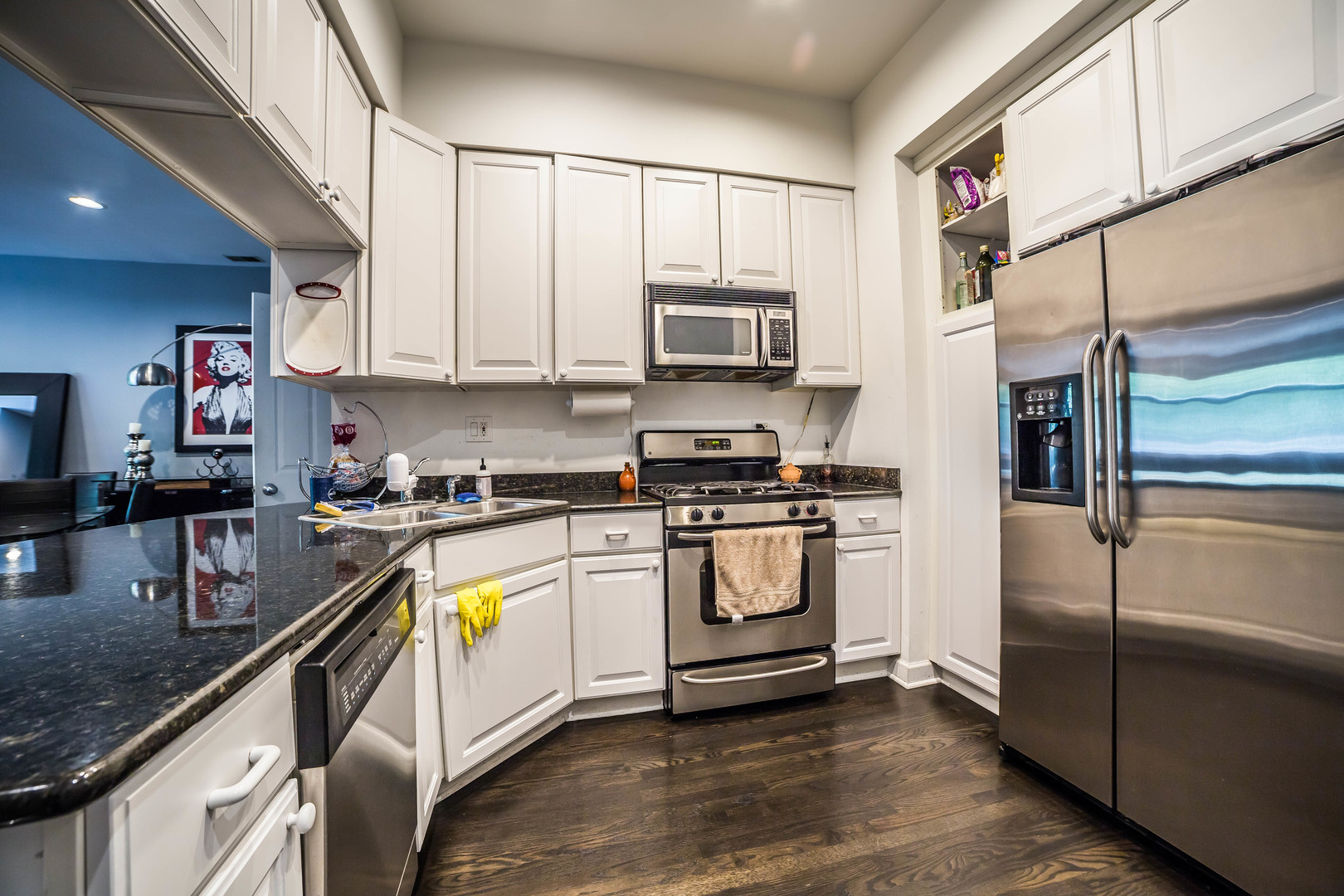 2629 North Ashland Avenue, Unit 2A Chicago, IL 60614 - Photo 10 of 19 a kitchen with stainless steel appliances granite countertop a refrigerator a stove and a sink with wooden floor