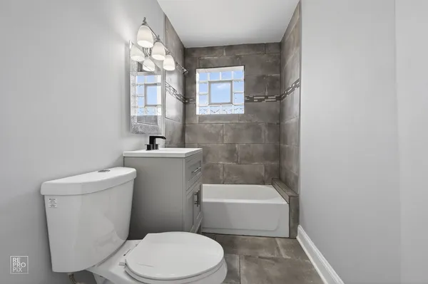 a white toilet sitting next to a bathroom sink