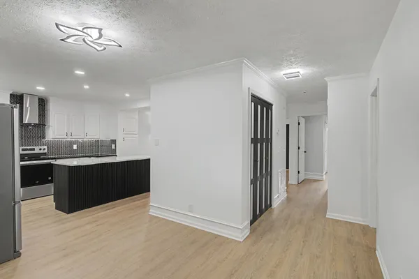a kitchen with a refrigerator and a sink