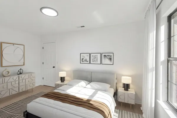 a bedroom with a bed and a couch