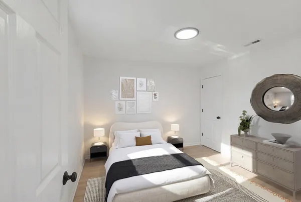 a bedroom with bed and a couch