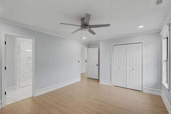 a bedroom with furniture and a large window