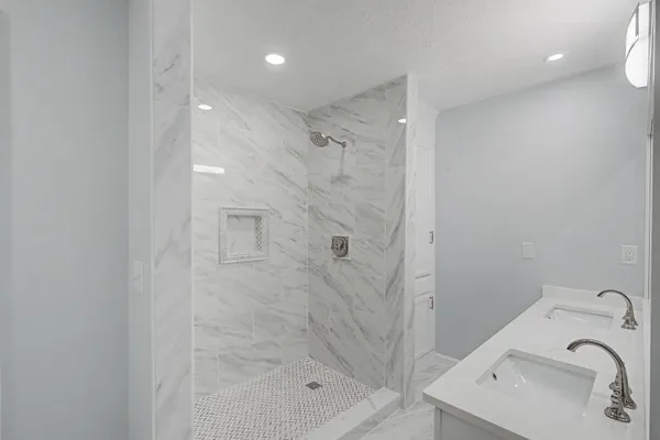 a bathroom with a sink a mirror and shower