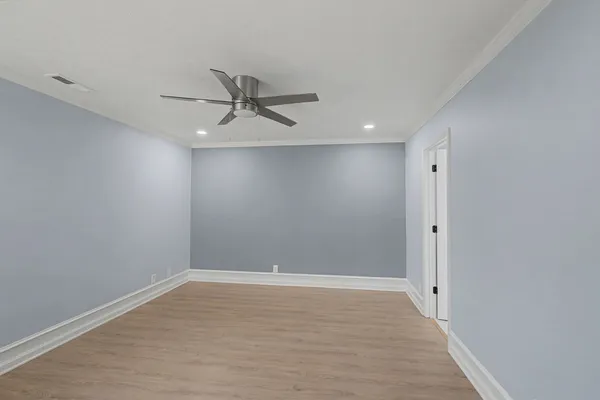 a view of an empty room with a ceiling fan