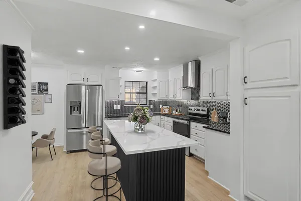 a kitchen with refrigerator and cabinets