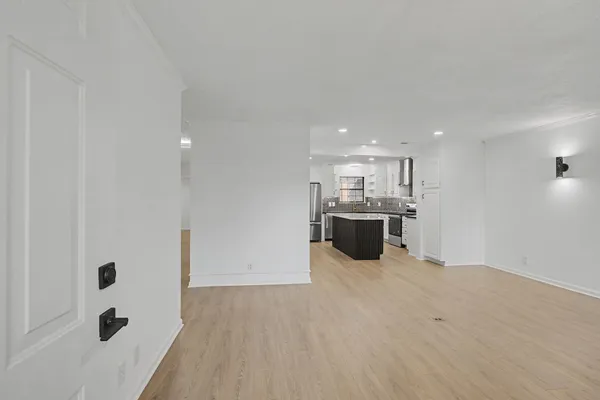 a view of a kitchen with a sink and a refrigerator