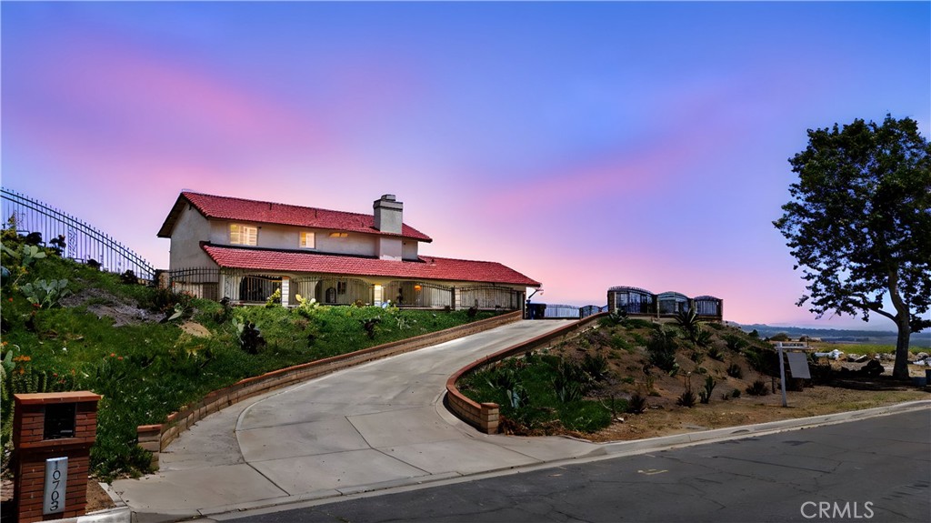 a front view of a house with a yard and balcony