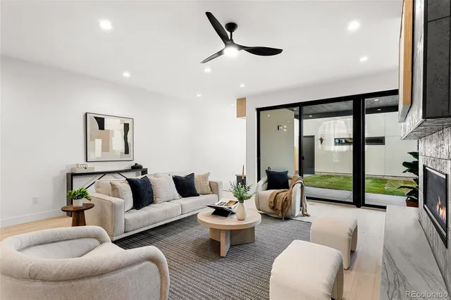 a living room with furniture and a floor to ceiling window