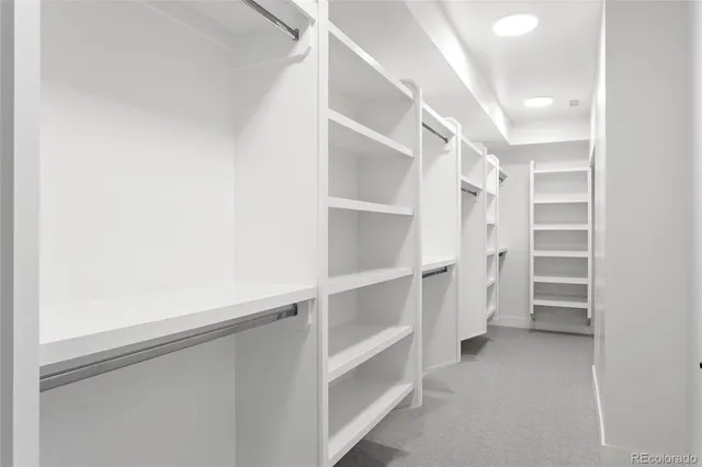 a view of walk in closet with empty racks