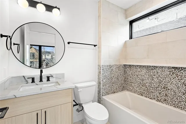 a bathroom with a sink toilet and a mirror