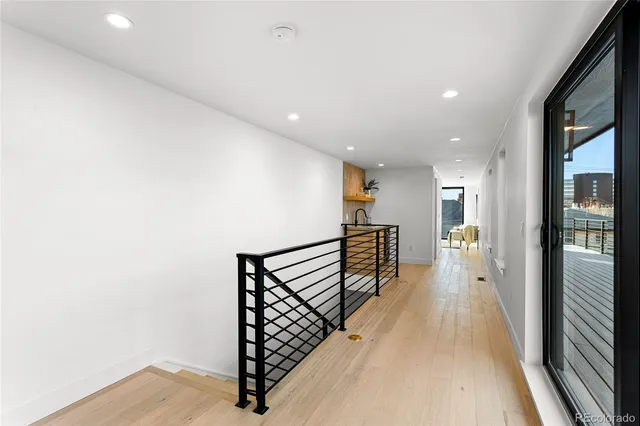 a view of hallway with wooden floor