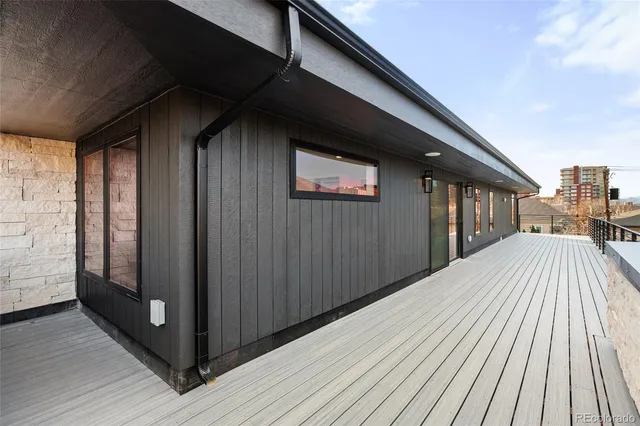a view of balcony with wooden floor and fence