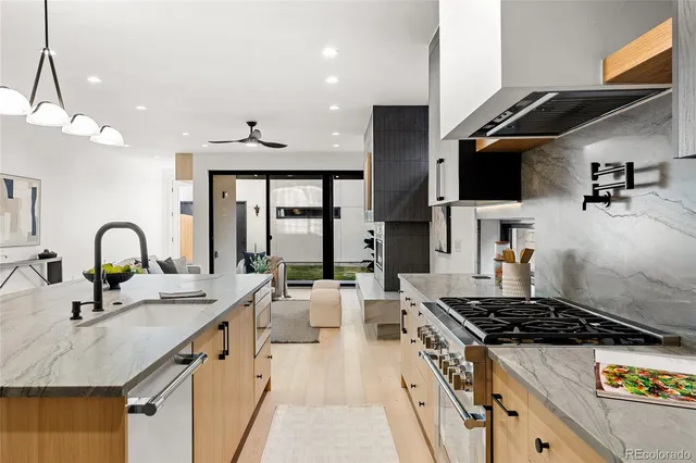 a kitchen with stainless steel appliances a sink a stove and a microwave