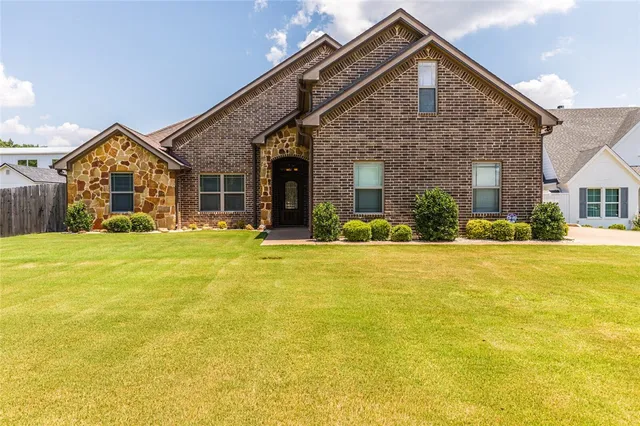 a front view of house with yard and outdoor seating