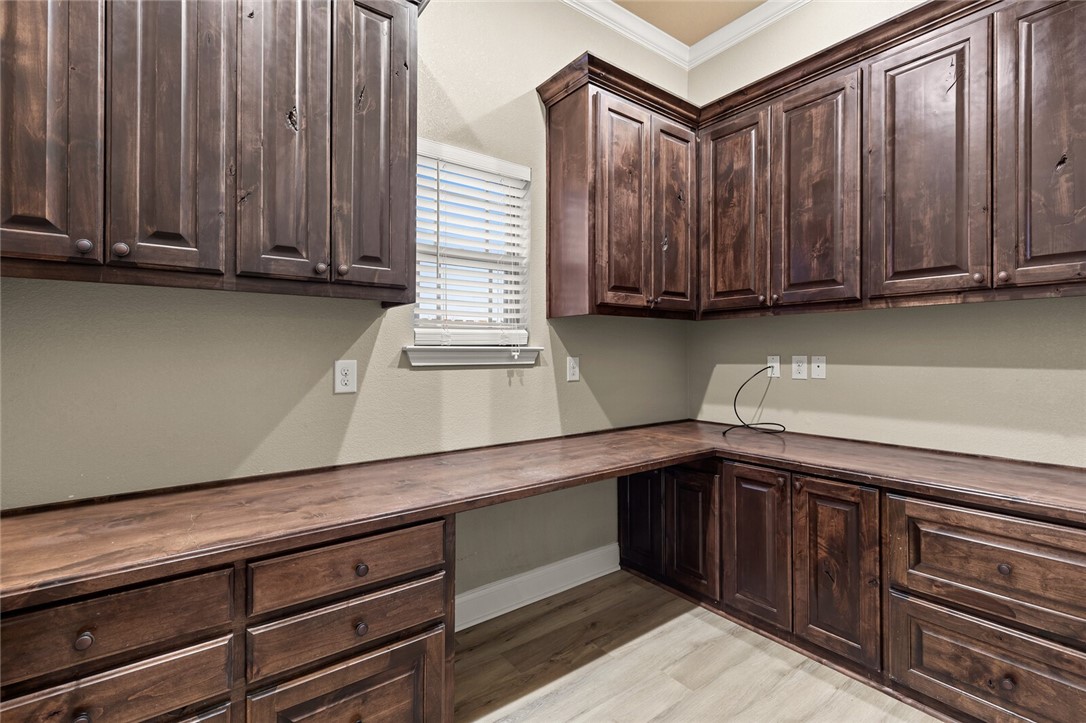 61 North Shore Circle Waco, TX 76708 - Photo 26 of 59 a kitchen with wooden cabinets and a sink