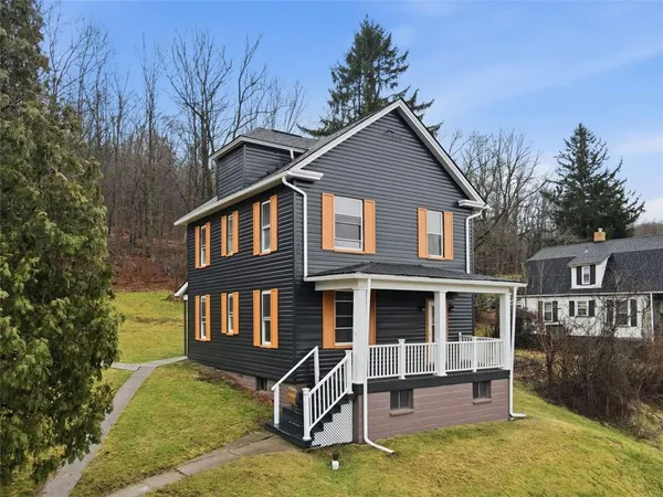 a front view of a house with yard porch and furniture