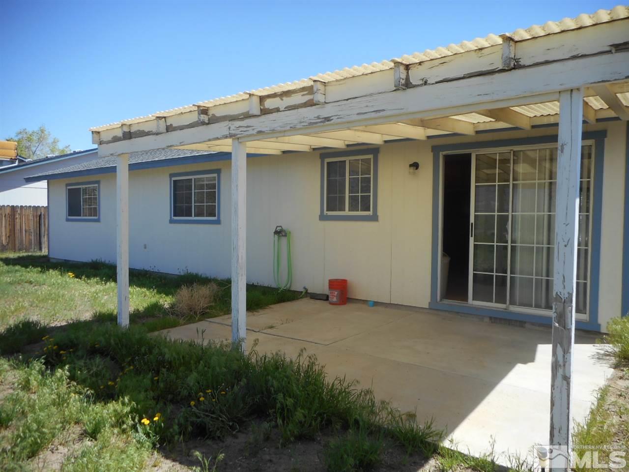 555 Yellow Jacket Road Dayton, NV 89403 - Photo 8 of 17 a view of backyard with potted plants and wooden fence