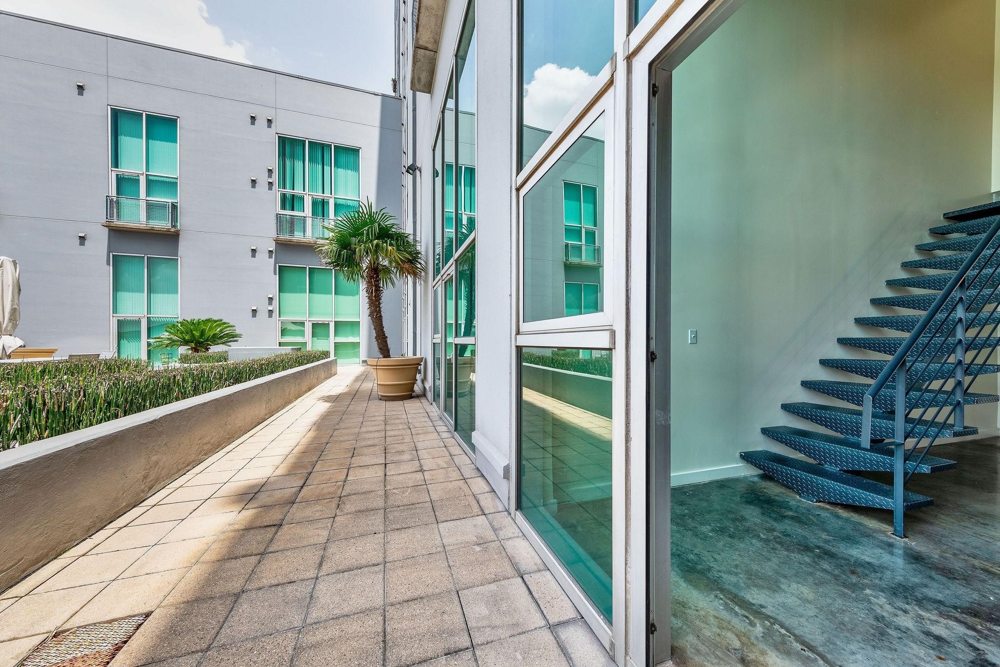 2000 Bagby Street, Unit 5423 Houston, TX 77002 - Photo 13 of 32 Right outside your unit you can walk to the zen community garden with an outdoor grill and lounge chairs.