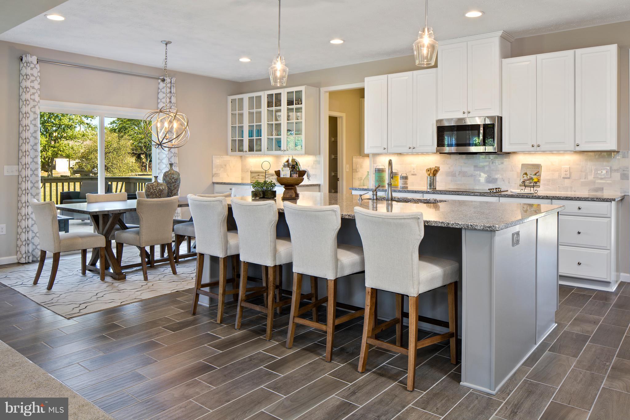 3118 Roderick Road Frederick, MD 21704 - Photo 5 of 25 a large kitchen with lots of counter space and dining table