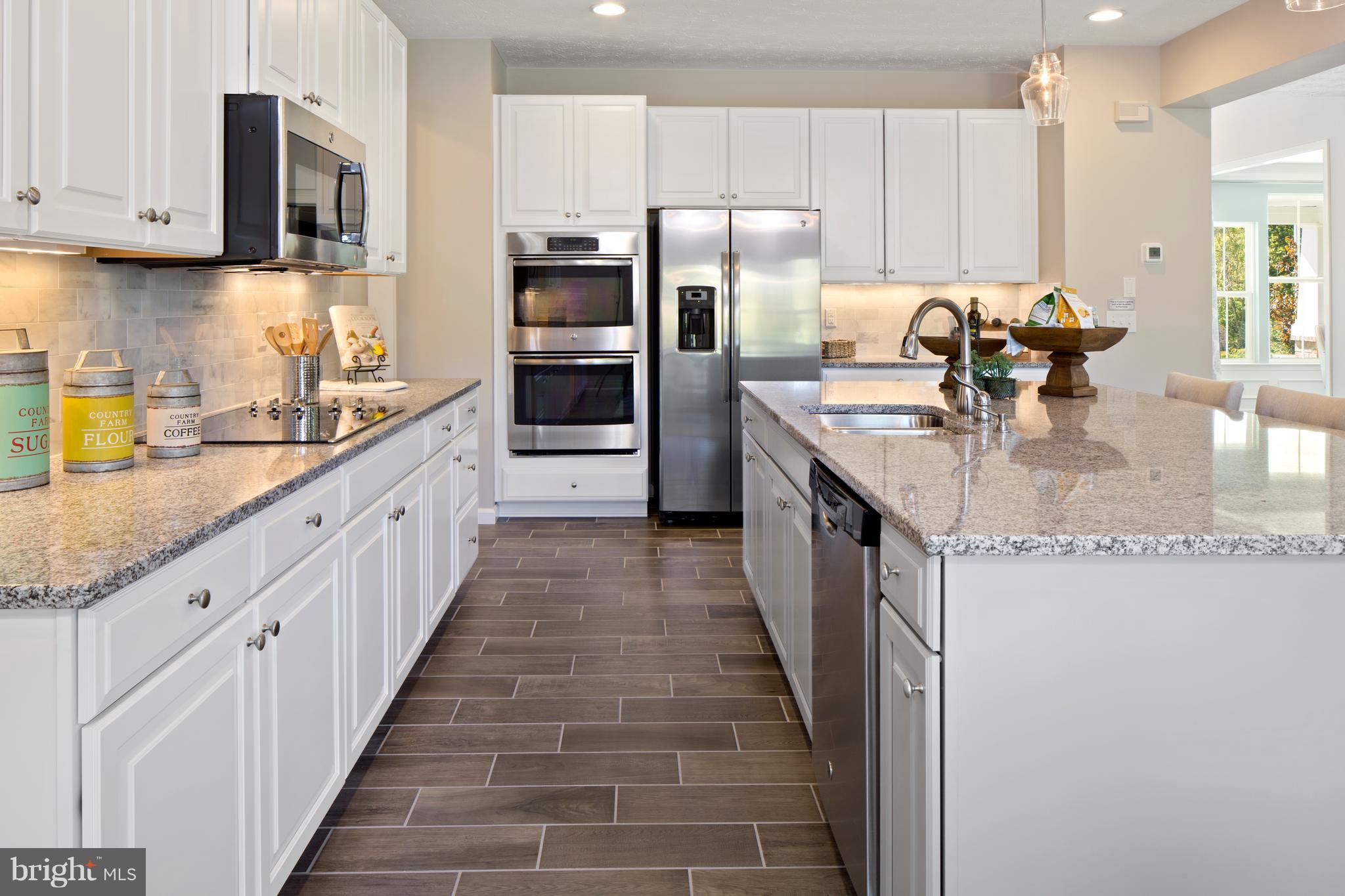 3118 Roderick Road Frederick, MD 21704 - Photo 8 of 25 a large kitchen with stainless steel appliances granite countertop a lot of counter space and a sink
