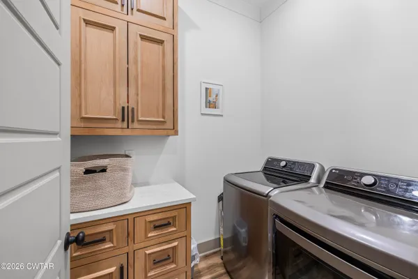 a view of a storage and utility room with washer and dryer