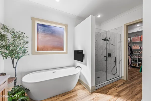 a bathroom with a bathtub and a shower