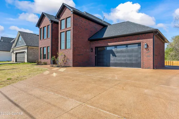 a view of an house with backyard of a house