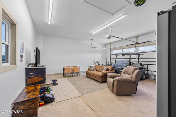 a livingroom with furniture cabinet and a window