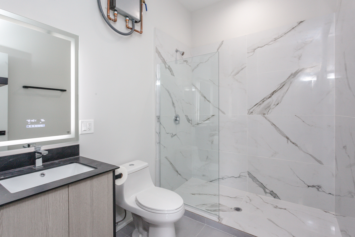 818 West 18th Street, Unit 4M Chicago, IL 60608 - Photo 5 of 10 a bathroom with a sink a toilet and shower