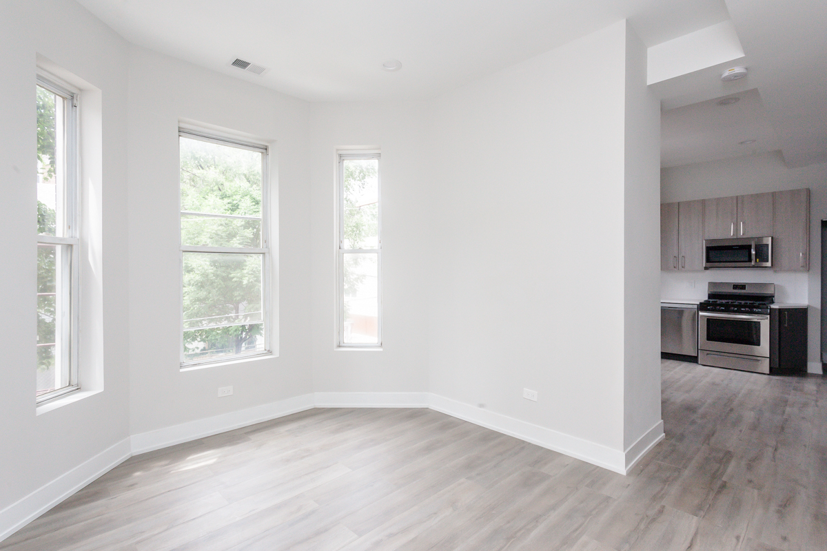 818 West 18th Street, Unit 4M Chicago, IL 60608 - Photo 6 of 10 a view of a kitchen and an entryway with wooden floor