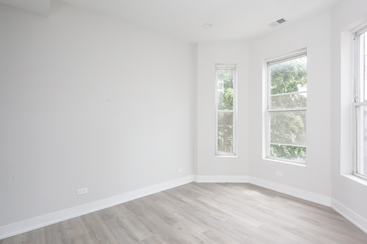 818 West 18th Street, Unit 4M Chicago, IL 60608 - Photo 8 of 10 an empty room with wooden floor and windows