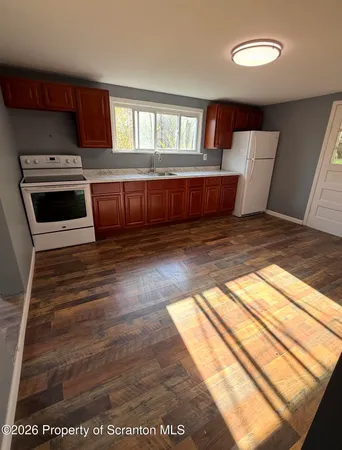 a view of kitchen and wooden floor