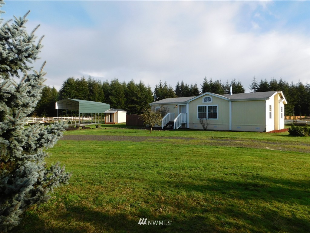 18022 Lawton Lane Southwest Rochester, WA 98579 - Photo 1 of 25 a front view of a house with a garden