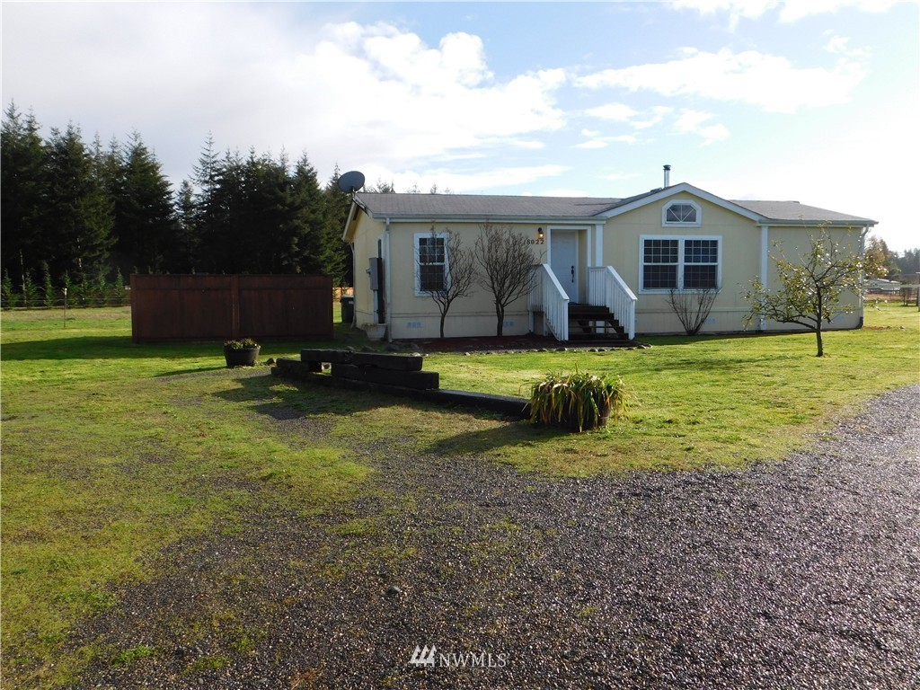 18022 Lawton Lane Southwest Rochester, WA 98579 - Photo 2 of 25 a front view of a house with a yard