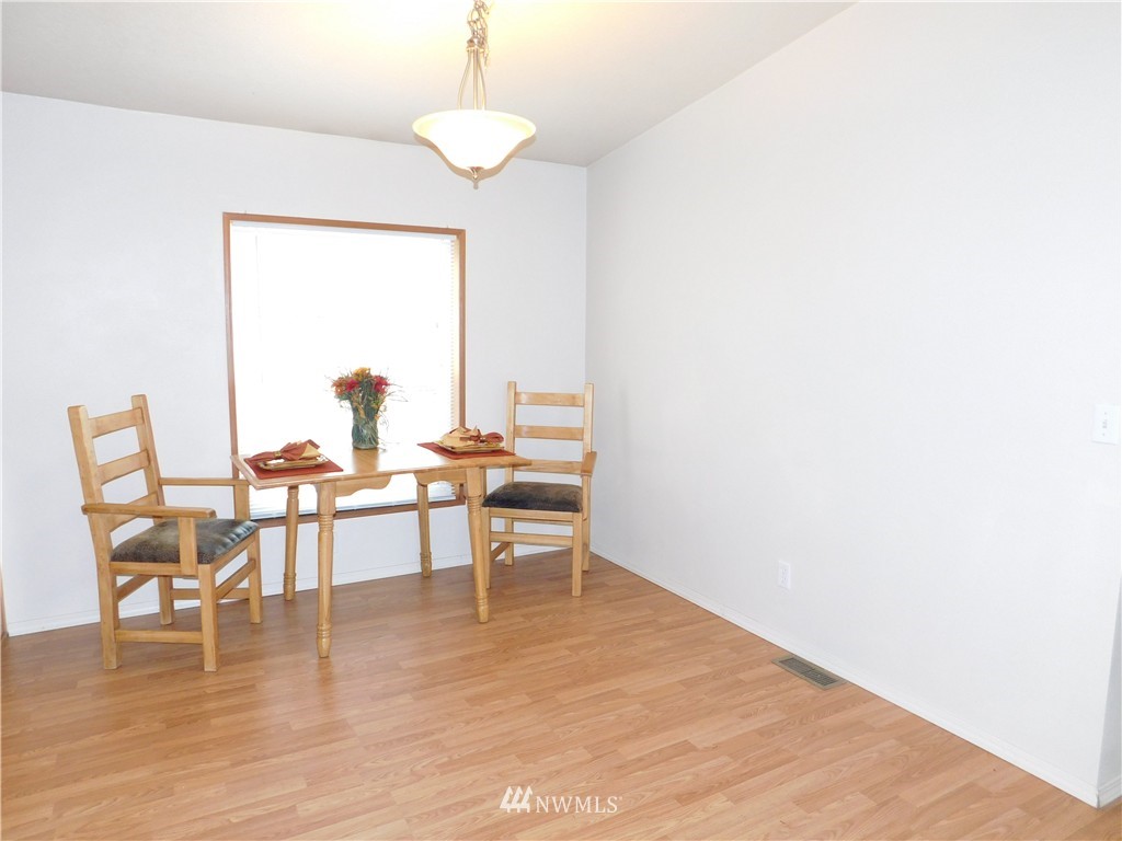 18022 Lawton Lane Southwest Rochester, WA 98579 - Photo 11 of 25 a view of a dining room with furniture window and wooden floor